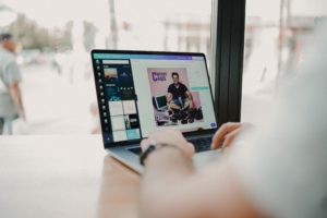 man creating marketing assets on laptop with Canva