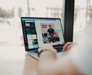 man creating marketing assets on laptop with Canva