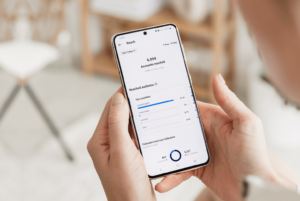 a person holding a phone and tracking social media metrics